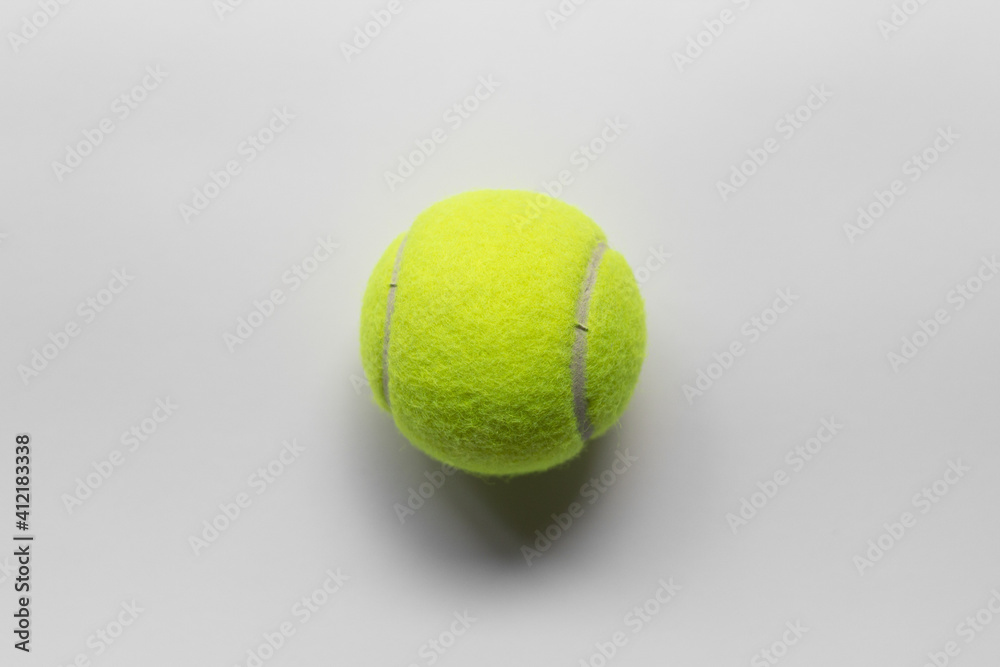 Yellow tennis ball over a white background