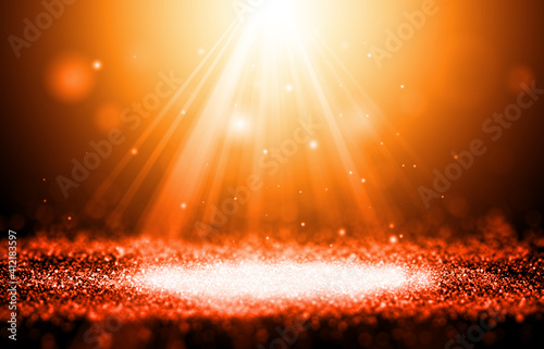 Gold and Orange color sparkle rays glitter lights with spotlight bokeh elegant show on stage abstract background. Dust sparks background.Spotlight background