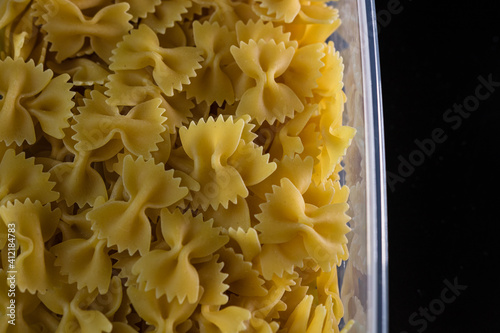 Close up of dry uncooked farfalle pasta isolated. photo