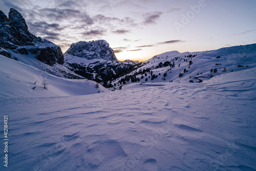 Winter sunset view of Sassolungo (Langkofel) peak in Dolomites, South Tyrol, Italy. Beautiful winter alpine landscape covered in snow. Sassolungu and Sasso Piato from Gardena pass, Dolomiti. photo