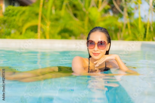 Portrait beautiful young asian woman relax smile enjoy leisure around swimming pool © siraphol