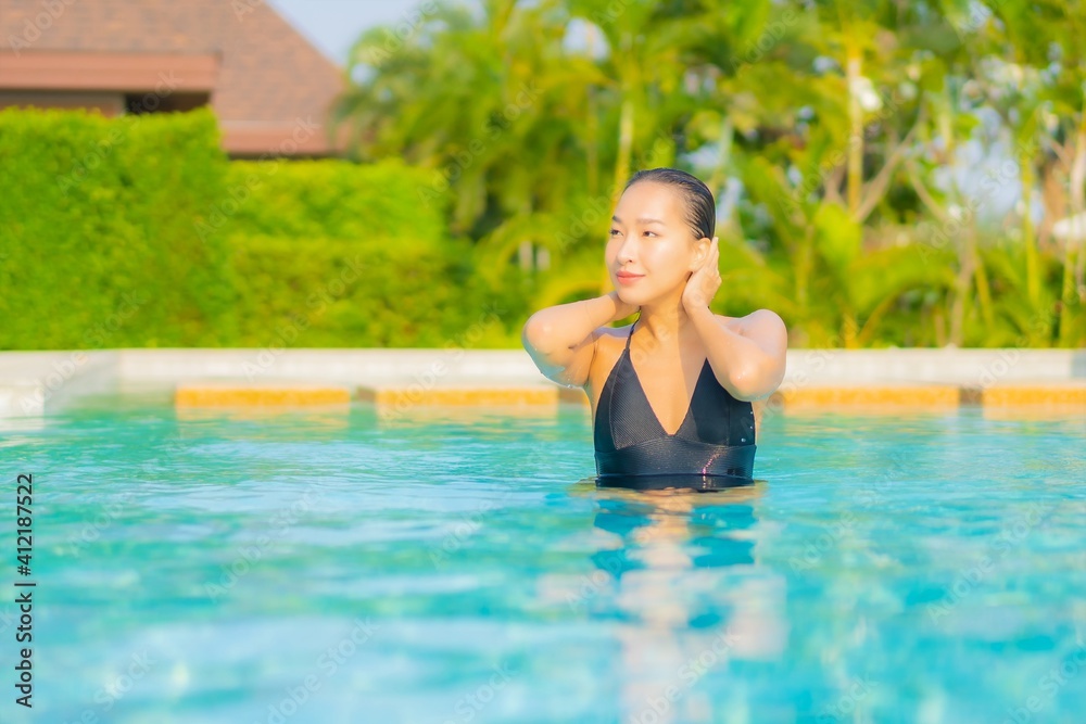 Portrait beautiful young asian woman relax smile enjoy leisure around swimming pool