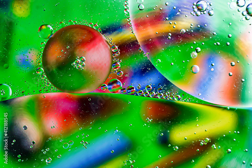 oil drops on water on a multicolored background