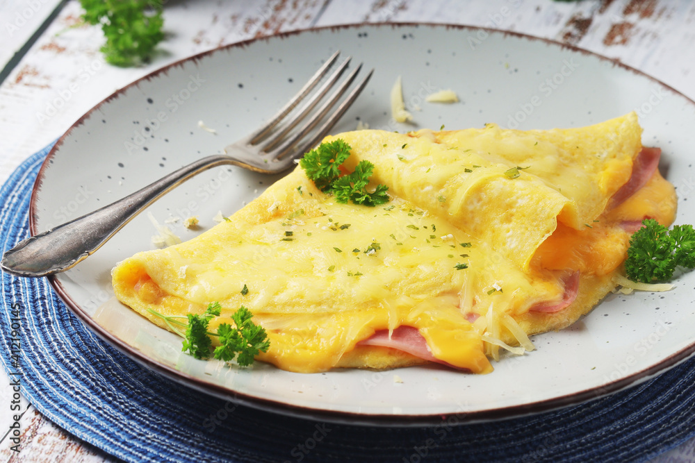 Omelette with ham and cheese on the plate Omelette with ham and cheese on the plate
