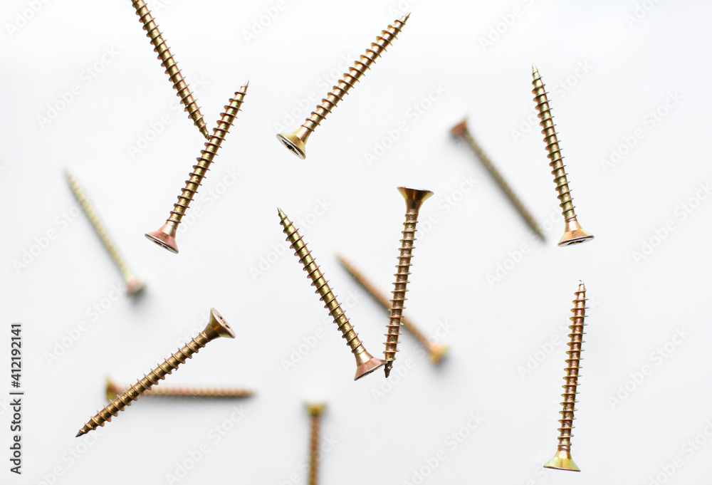 Collection of screw heads. Background of screws and dowels. Levitation of objects on a white background Collection of screw heads. Background of screws and dowels. Levitation of objects on a white background