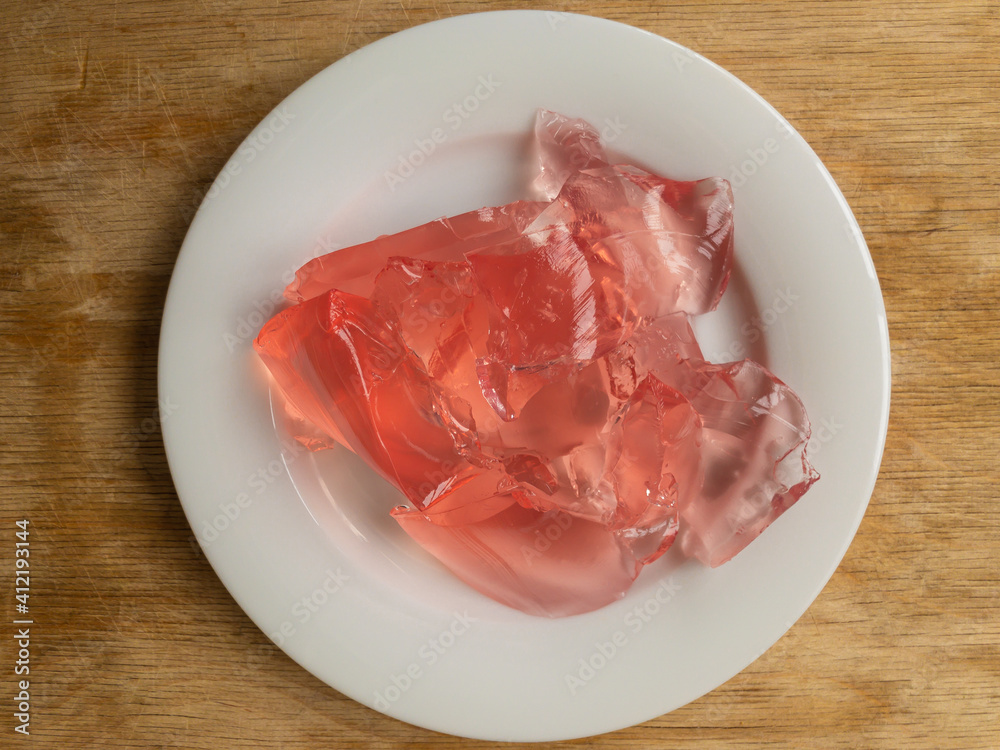 Top view on white plate full of strawberry jelly Top view on white plate full of strawberry jelly