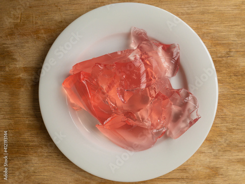 Top view on white plate full of strawberry jelly photo