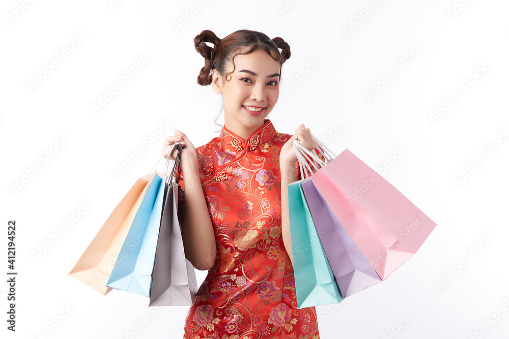 Asian chinese woman in traditional dress on white background with shopping bags. Chinese new year festival. Asian chinese woman in traditional dress on white background with shopping bags. Chinese new year festival.