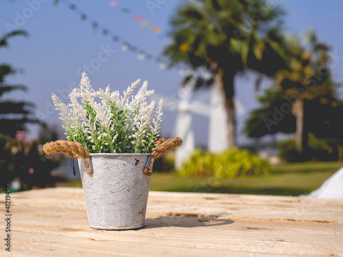 A flowerpot placed on a wooden table