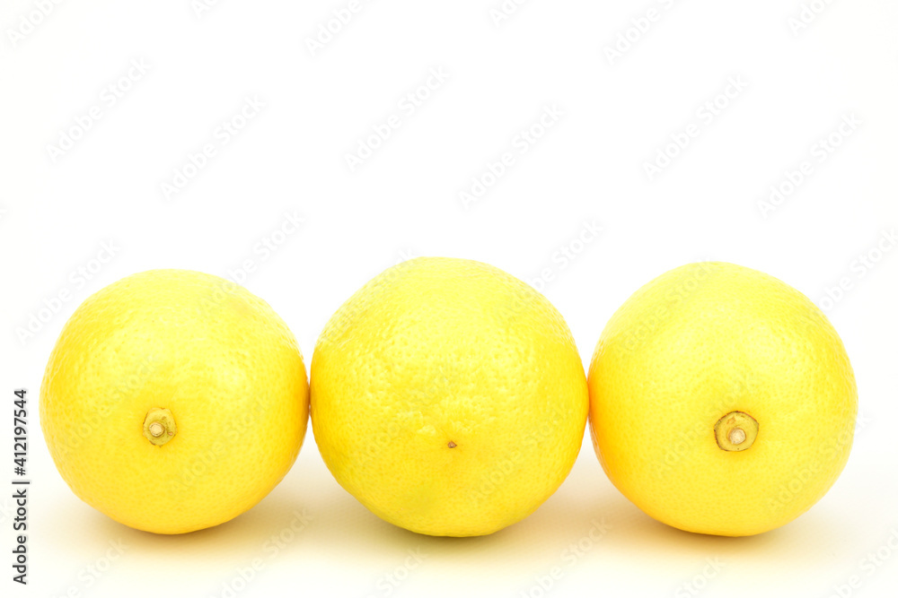 Three lemons, laid out in a row and isolated on a white background. Three lemons, laid out in a row and isolated on a white background.