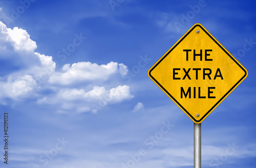 Road sign message for the extra mile photo