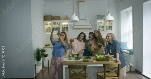 Young women come to the friend's house. They happy to see each other. They smile, laug, hug and take a selfie