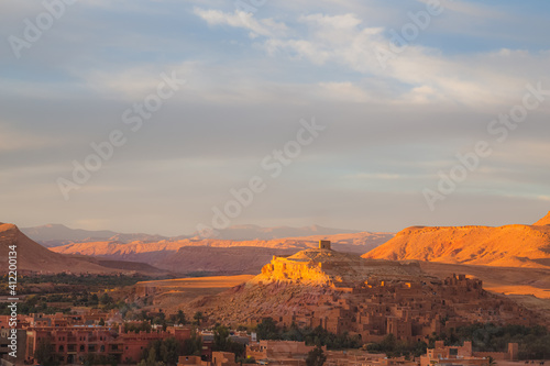 A sunset or sunrise view with dramatic light of old town Ait Benhaddou, Morocco a historic fortified village, noted for its ancient clay earthen architecture.