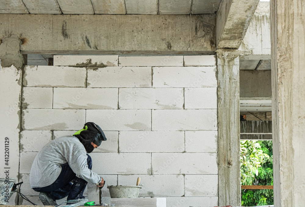 worker use trowel with liquid cement making coner beads in house site building worker use trowel with liquid cement making coner beads in house site building