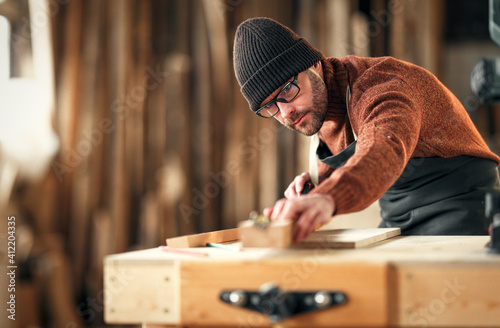 Joiner working with wooden detail in workshop