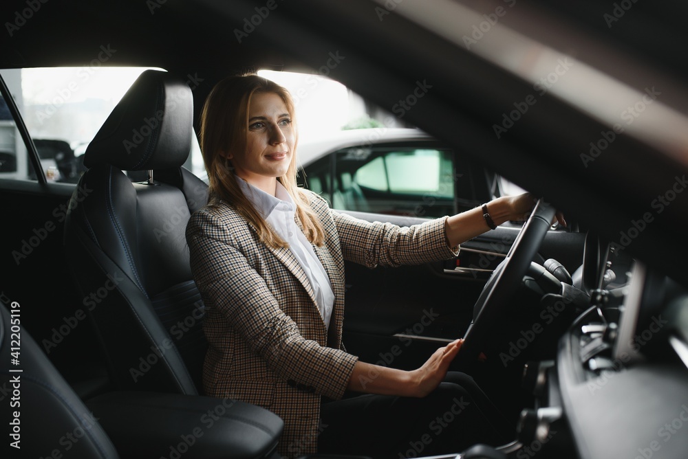 young beautiful business woman sitting in her car young beautiful business woman sitting in her car