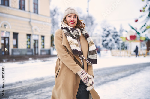 Smiling beautiful woman enjoying winter time outdoors