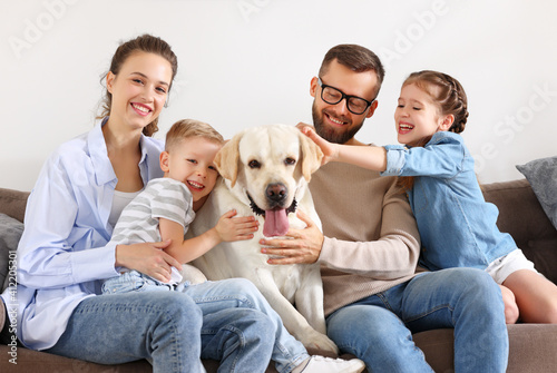 happy family playing with their favorite pet dog at home