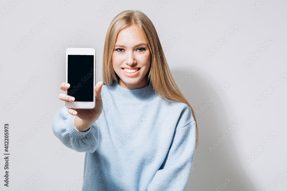 Beautiful model showing empty phone screen Beautiful model showing empty phone screen