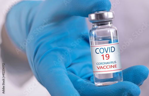 Development and creation of a coronavirus vaccine COVID-19 .Coronavirus Vaccine concept in hand of doctor blue vaccine jar. Vaccine Concept of fight against coronavirus.