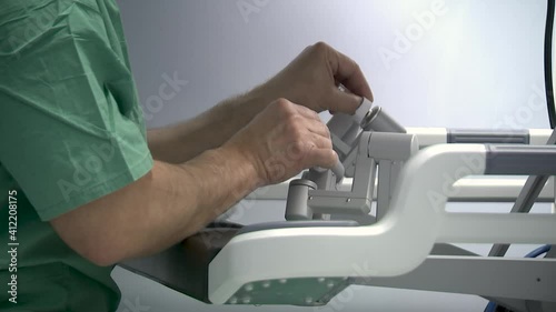 Medical robot da Vinci. Surgeon controlling medical robot da Vinci.