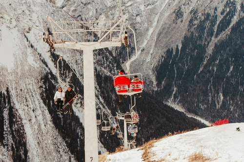 Cable car in the mountains in winter. Photo of the chairlift. Dombay ski resort in Russia. 