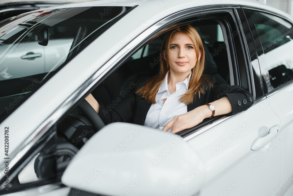 young beautiful business woman sitting in her car young beautiful business woman sitting in her car