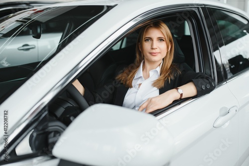 young beautiful business woman sitting in her car © Serhii