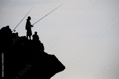 silhouette of a fisherman