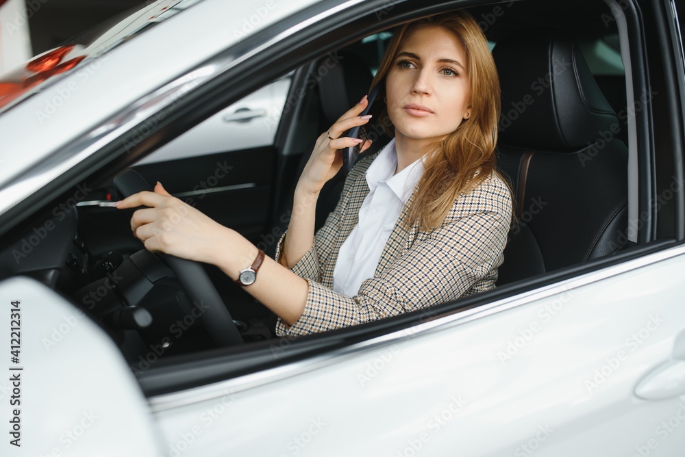 young beautiful business woman sitting in her car