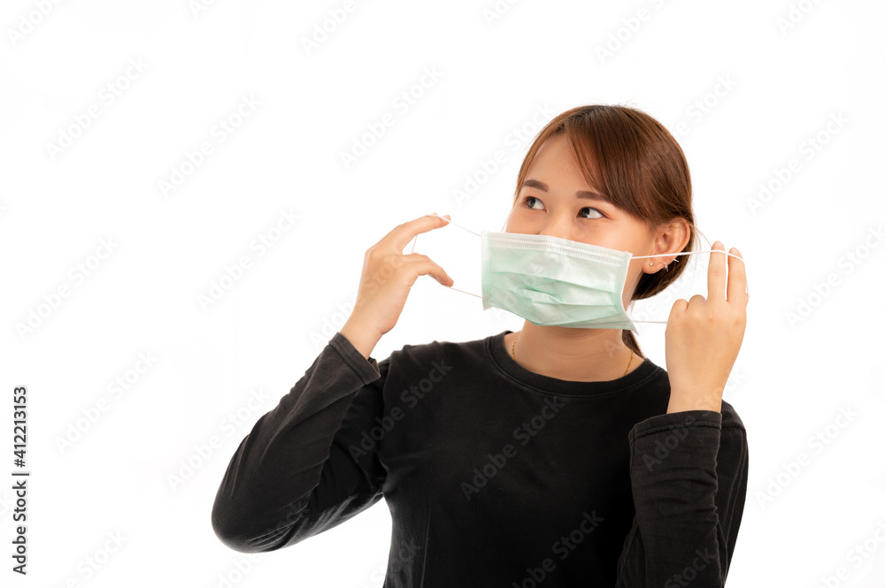 Young nice asian girl with blonde hair wearing hygienic protective surgical mask to prevent airborne disease infection, isolated on white background Young nice asian girl with blonde hair wearing hygienic protective surgical mask to prevent airborne disease infection, isolated on white background