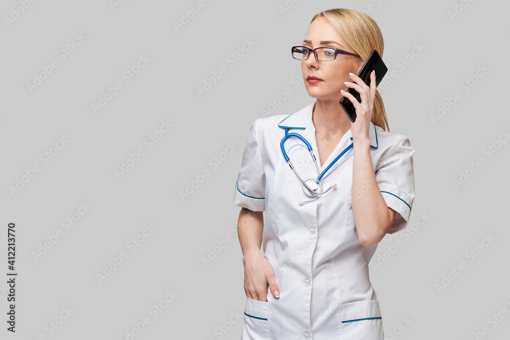 Portrait of a female doctor ornurse talking on the mobile phone Portrait of a female doctor ornurse talking on the mobile phone