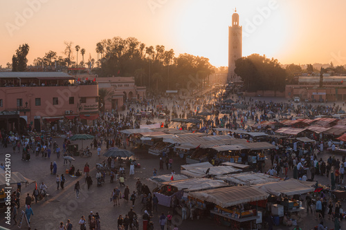 Overlooking the historic main square market of Jemaa el-Fna in the medina of Marrakech, Morocco at sunset.
