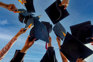 Graduates throwing graduation hats Up in the sky