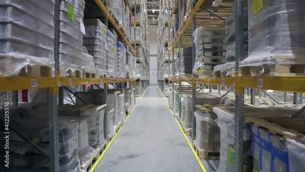 Camera moving through warehouse. racks with merchandise. rows shelves with cardboard boxes. storage room. Logistics center interior. concept nobody, goods, storehouse. Camera moving through warehouse. racks with merchandise. rows shelves with cardboard boxes. storage room. Logistics center interior. concept nobody, goods, storehouse.