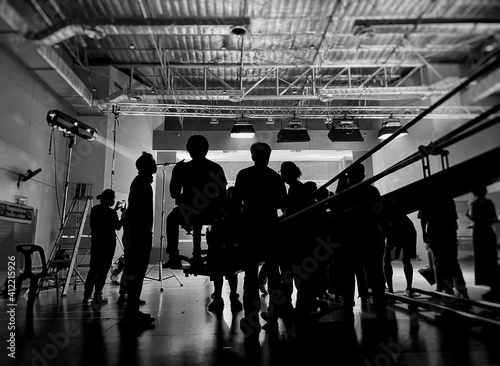Valokuva Blurred behind the scenes of music video shooting production crew team silhouette and camera equipment in studio