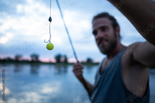 Angler using a pop up rig for carp fishing photo