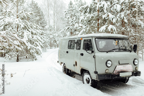 the car got stuck in the winter in the forest, bad weather after a heavy snowfall completely covered the roads, waiting for a tow truck far outside the city