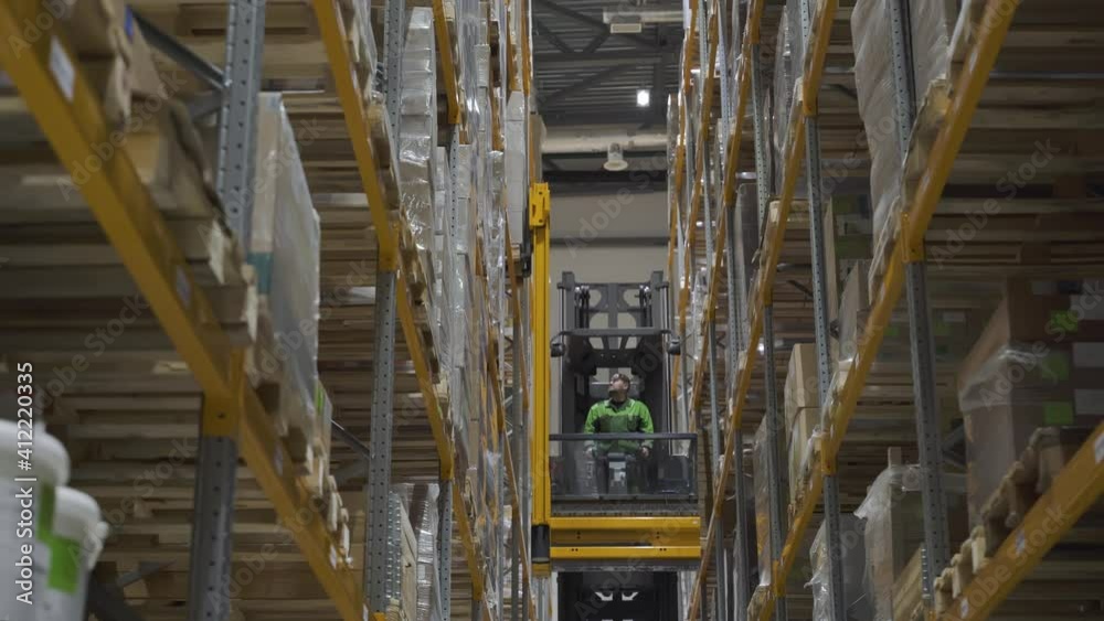 large logistics commerce structure with boxes on the shelf. industry concept. warehouse worker using car and forklift, loading lifting cardboard goods for transnational export