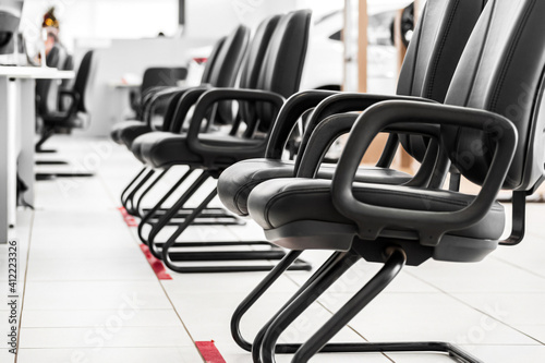 Chairs in line of a service queue of a shop. Queue line, concept of waiting for attendance.