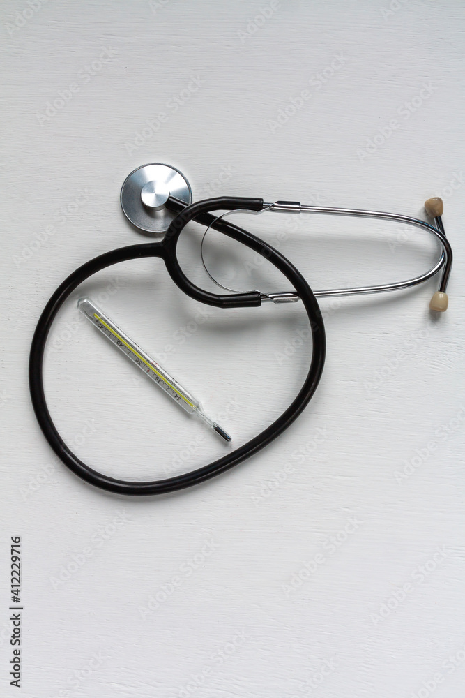 a stethoscope and a thermometer on white background a stethoscope and a thermometer on white background