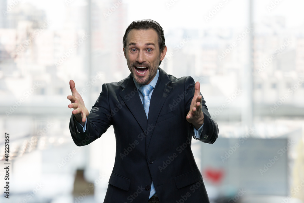 Happy positive boss congratulating you with birthday. Bright office on the background. Happy positive boss congratulating you with birthday. Bright office on the background.
