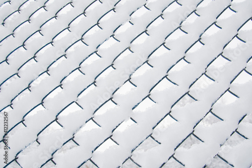 View of the snow-covered mesh netting. Background concept, nature.