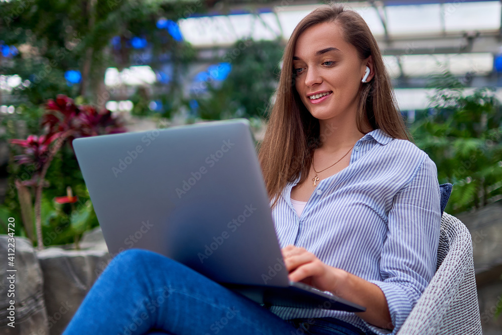 Modern smart freelancer woman remotely working online at a laptop Modern smart freelancer woman remotely working online at a laptop