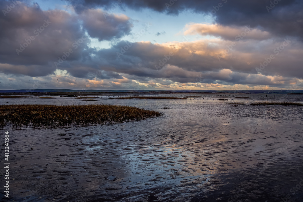 Evening clouds reflect on mud and water in the Skern area of Northam Burrows, near Appledore, North Devon. Evening clouds reflect on mud and water in the Skern area of Northam Burrows, near Appledore, North Devon.
