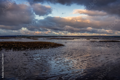 Evening clouds reflect on mud and water in the Skern area of Northam Burrows  near Appledore  North Devon.