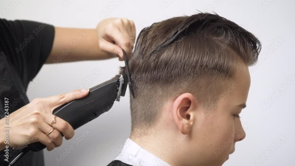 Cutting the hair at the back of the head with a hair clipper. Cutting the hair at the back of the head with a hair clipper.