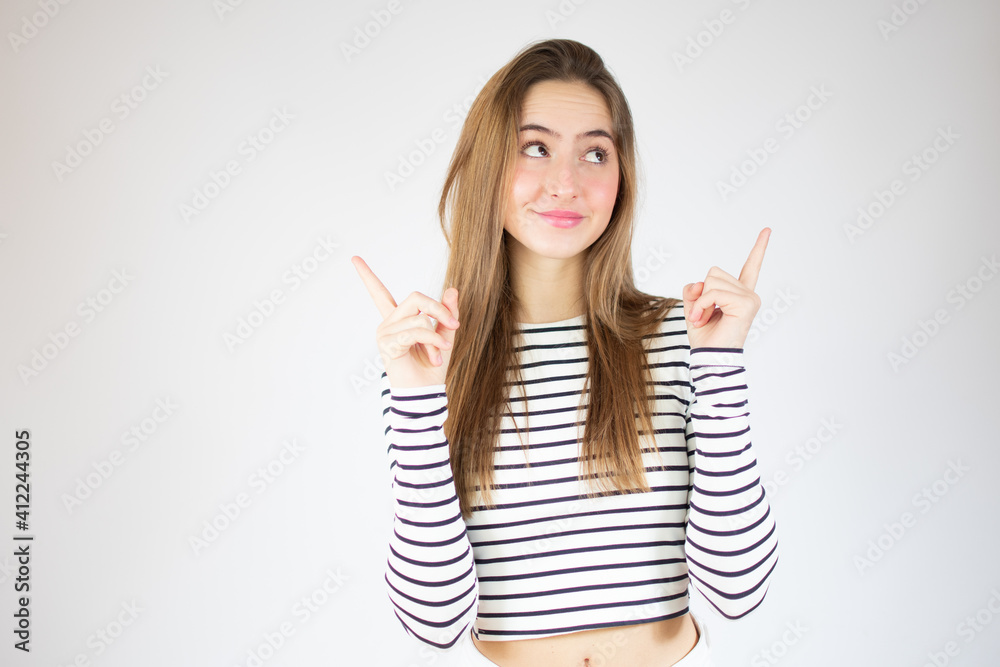 Portrait of beautiful young woman standing over isolated white background showing and pointing up with fingers number one Portrait of beautiful young woman standing over isolated white background showing and pointing up with fingers number one