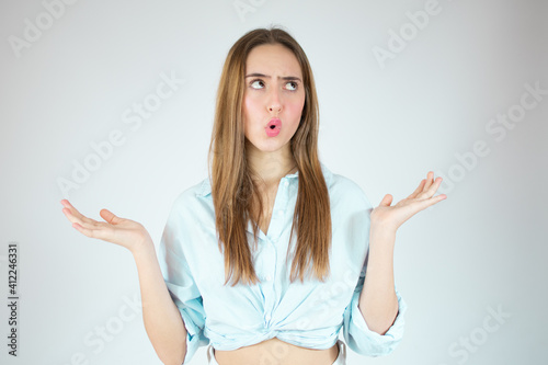 Young woman over isolated white background thinking an idea while looking up