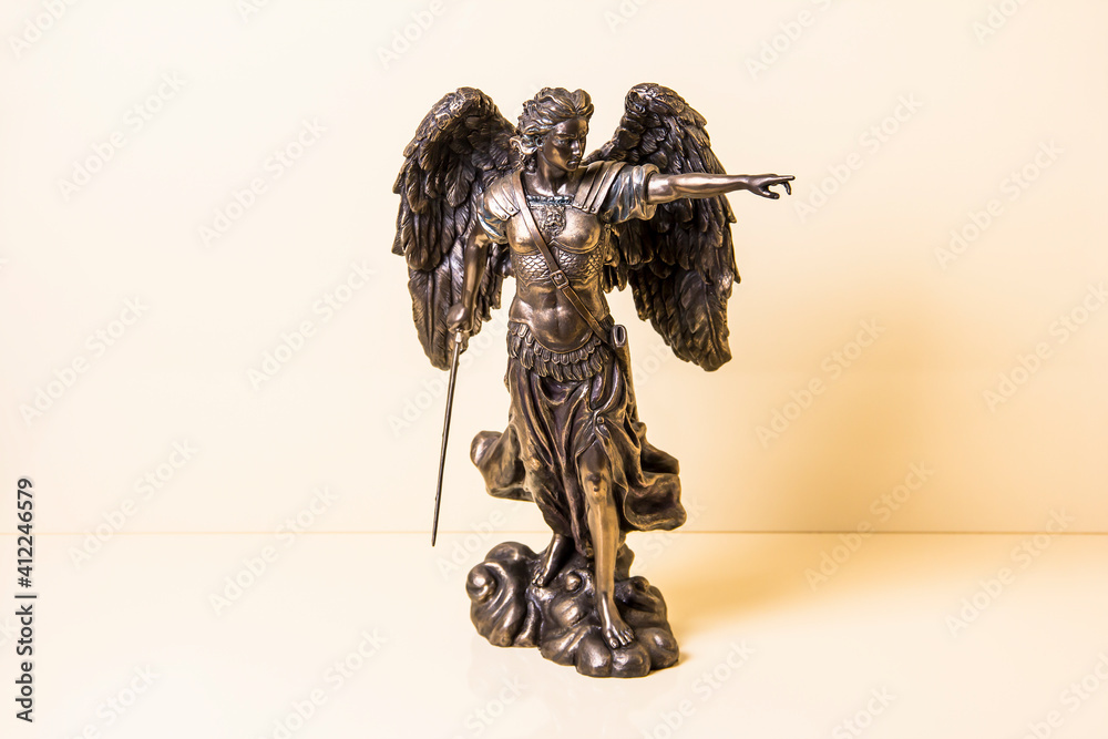 Statuette of Archangel Michael with wings and sword. Stock Photo ...